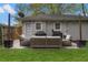 Charming backyard featuring a patio seating area with a grill and mature trees, perfect for relaxing and entertaining outdoors at 1963 Main Nw St, Atlanta, GA 30318