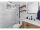 Modern bathroom features white subway tile shower, wood vanity, and stylish fixtures at 1963 Main Nw St, Atlanta, GA 30318