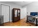 Bright bedroom featuring hardwood floors, closet, and an inviting workspace with a modern desk and chair at 1963 Main Nw St, Atlanta, GA 30318