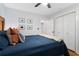 Comfortable bedroom featuring blue bedding, white trim, and a ceiling fan at 1963 Main Nw St, Atlanta, GA 30318