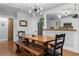Dining room with hardwood floors, modern light fixture, and adjacent kitchen area at 1963 Main Nw St, Atlanta, GA 30318