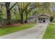 Charming home with a long driveway leading to a covered porch and a well-manicured front lawn at 1963 Main Nw St, Atlanta, GA 30318