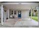 Covered porch with seating, a blue front door, and neutral paint at 1963 Main Nw St, Atlanta, GA 30318
