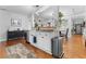 Open concept kitchen with white cabinetry, stainless steel appliances, and hardwood flooring at 1963 Main Nw St, Atlanta, GA 30318