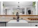Farmhouse sink with black fixtures and granite countertops with decorative plants around window at 1963 Main Nw St, Atlanta, GA 30318