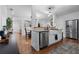 Open-concept kitchen featuring a farmhouse sink, stainless steel appliances, and hardwood floors at 1963 Main Nw St, Atlanta, GA 30318