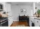 Modern kitchen boasts stainless steel appliances, white cabinets, hardwood floors, and stylish decor at 1963 Main Nw St, Atlanta, GA 30318