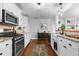 Bright kitchen with stainless steel appliances, white cabinets, and hardwood floors at 1963 Main Nw St, Atlanta, GA 30318