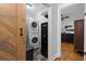 Cozy laundry area featuring a stacked washer and dryer, conveniently located near a bedroom for added ease at 1963 Main Nw St, Atlanta, GA 30318