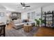 Bright living room featuring hardwood floors, a ceiling fan, and a cozy sectional sofa at 1963 Main Nw St, Atlanta, GA 30318