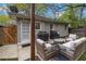 This patio includes outdoor seating around a small table, string lights, and two barbecues at 1963 Main Nw St, Atlanta, GA 30318