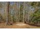Backyard firepit and seating area surrounded by mature trees, perfect for enjoying outdoor gatherings at 240 Arthurs Ln, Covington, GA 30016