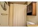 Bathroom with shower-tub combo and wooden cabinet at 240 Arthurs Ln, Covington, GA 30016