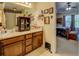 Bathroom featuring double sinks and wood cabinets at 240 Arthurs Ln, Covington, GA 30016
