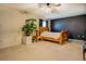 Spacious bedroom with neutral carpet, painted accent wall, and a large window at 240 Arthurs Ln, Covington, GA 30016