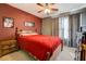 Cozy bedroom with a ceiling fan, stylish decor, and a comfortable queen-sized bed at 240 Arthurs Ln, Covington, GA 30016