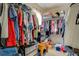 Walk-in closet full of hanging clothes and boxes at 240 Arthurs Ln, Covington, GA 30016