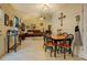 Dining area leading into a cozy living space and kitchen with warm, neutral walls at 240 Arthurs Ln, Covington, GA 30016