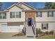 Close up of inviting two-story home featuring brick accents, a garage, and well-maintained landscaping at 240 Arthurs Ln, Covington, GA 30016