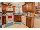 Well-lit kitchen with white oven, backsplash, and dark wood cabinets with lots of decor at 240 Arthurs Ln, Covington, GA 30016