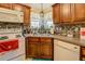 Cozy kitchen with white appliances and corner sink at 240 Arthurs Ln, Covington, GA 30016