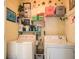 Practical laundry room with a washer, dryer, and ample storage at 240 Arthurs Ln, Covington, GA 30016