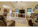 Spacious living room adjacent to kitchen featuring comfortable seating and decor at 240 Arthurs Ln, Covington, GA 30016