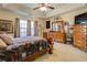 Bright bedroom featuring ceiling fan, crown molding, and large windows at 240 Arthurs Ln, Covington, GA 30016