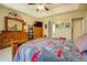 Bedroom with ceiling fan, crown molding, and tray ceiling at 240 Arthurs Ln, Covington, GA 30016