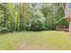 Expansive backyard featuring a fire pit and a deck perfect for outdoor gatherings and enjoying nature at 4558 Dorsett Shoals Ct, Douglasville, GA 30135