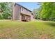 Spacious backyard with a deck, offering a peaceful outdoor retreat and space for recreation at 4558 Dorsett Shoals Ct, Douglasville, GA 30135