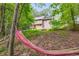 View of backyard featuring a hammock and fire pit, ideal for relaxation and outdoor enjoyment at 4558 Dorsett Shoals Ct, Douglasville, GA 30135