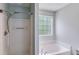 Bathroom showcasing a shower, soaking tub, and window at 4558 Dorsett Shoals Ct, Douglasville, GA 30135
