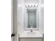Small bathroom with bright vanity lights and a decorative mirror at 4558 Dorsett Shoals Ct, Douglasville, GA 30135