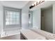 Bathroom featuring a soaking tub, a large window, and a vanity with sink at 4558 Dorsett Shoals Ct, Douglasville, GA 30135