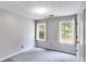 Bright bedroom with gray walls, neutral carpet, and two windows offering a view of the outdoors at 4558 Dorsett Shoals Ct, Douglasville, GA 30135