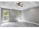 Spacious bedroom with neutral walls, two bright windows, and an elegant ceiling fan at 4558 Dorsett Shoals Ct, Douglasville, GA 30135