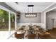 Dining room with sliding glass door to deck, and a modern light fixture at 4558 Dorsett Shoals Ct, Douglasville, GA 30135