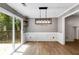 Dining room with sliding glass door to the deck, and a modern light fixture at 4558 Dorsett Shoals Ct, Douglasville, GA 30135