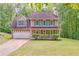 Charming two-story home with a two-car garage, a manicured lawn, and a welcoming front porch at 4558 Dorsett Shoals Ct, Douglasville, GA 30135