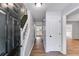 Entryway hallway with hardwood floors, staircase, and access to the kitchen at 4558 Dorsett Shoals Ct, Douglasville, GA 30135