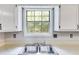 View of the kitchen sink in front of a window that looks out to the back yard at 4558 Dorsett Shoals Ct, Douglasville, GA 30135