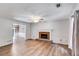 Large living room with a brick fireplace, ceiling fan, and natural light at 4558 Dorsett Shoals Ct, Douglasville, GA 30135