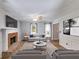 Cozy living room with brick fireplace, ceiling fan, and neutral decor at 4558 Dorsett Shoals Ct, Douglasville, GA 30135
