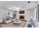 Comfortable living room with a brick fireplace, ceiling fan, and large window at 4558 Dorsett Shoals Ct, Douglasville, GA 30135