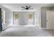 Large main bedroom with a ceiling fan, lots of light from two windows, and 2 doors at 4558 Dorsett Shoals Ct, Douglasville, GA 30135