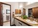 Bathroom featuring double sinks, shuttered windows, a large mirror, and a doorway leading to another room at 131 Cypress St, Roswell, GA 30075