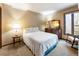 Cozy bedroom featuring a neutral color scheme and natural light from a large window at 131 Cypress St, Roswell, GA 30075