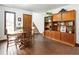 Dining area with brick flooring, wood furniture, a charming bookcase, and a staircase at 131 Cypress St, Roswell, GA 30075