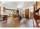 Open-concept dining area with an eat-in kitchen, brick floors, and adjacent staircase at 131 Cypress St, Roswell, GA 30075